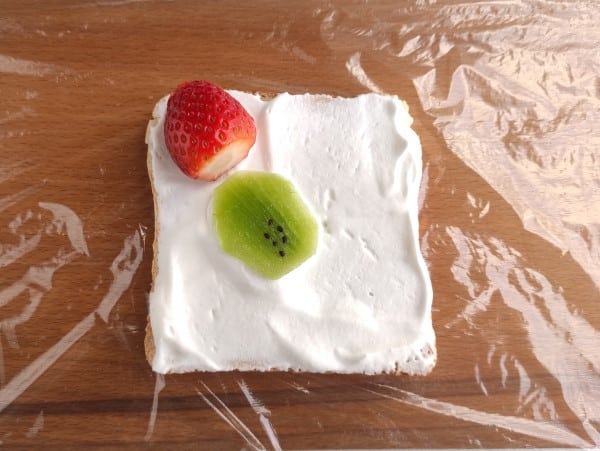 creative sandwich - strawberry and kiwi on bread with whipped cream