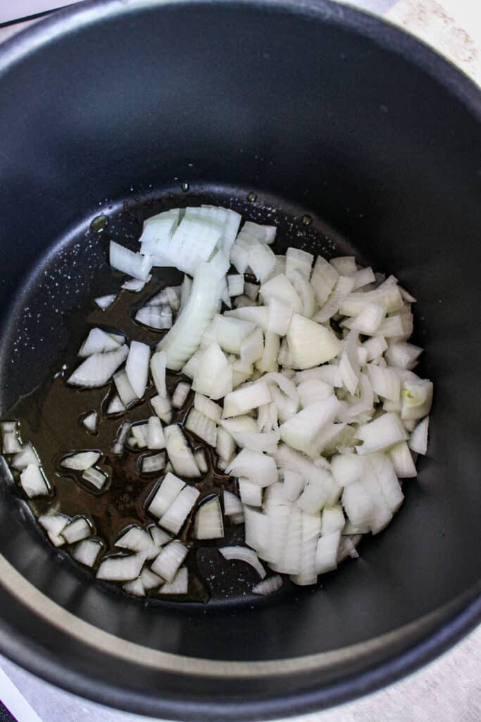 black bean cumin soup - onions in pot