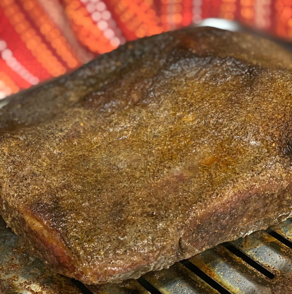 brisket on roasting pan after one hour of cooking