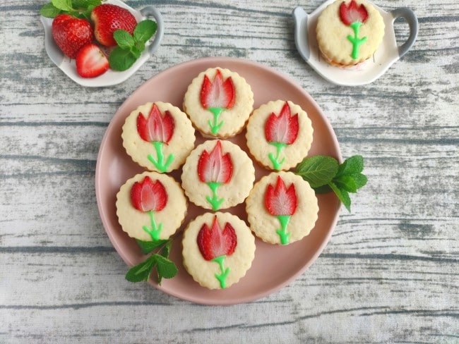 strawberry tulip cookies - seven decorated tulip cookies on a plate