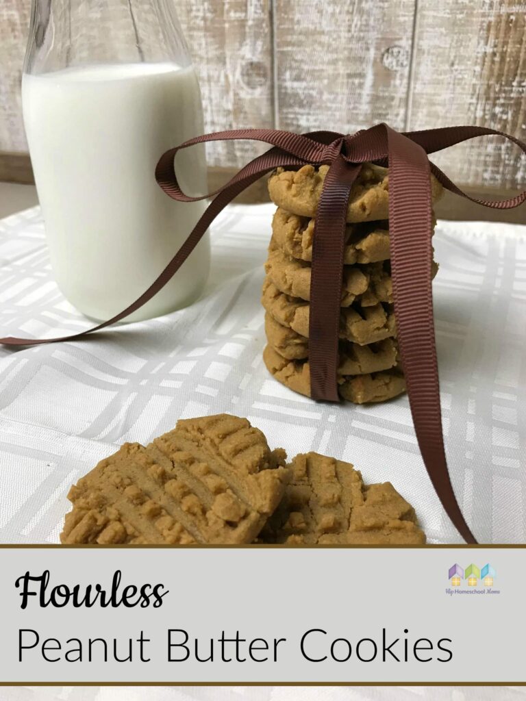 Flourless Peanut Butter Cookies Recipe a stack of cookies tied with a brown bow on a white tablecloth and a jug of milk