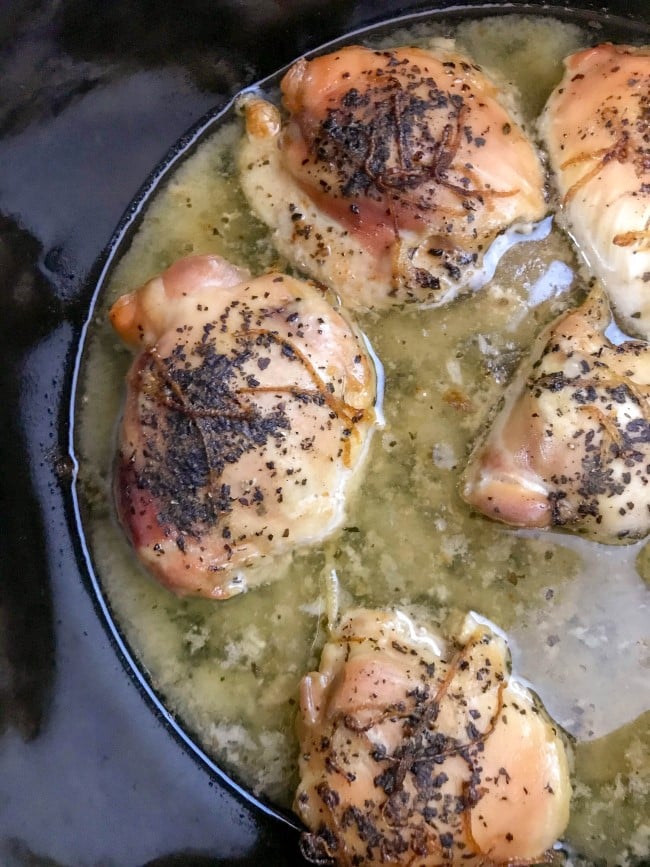 Lemon Basil Chicken Thighs - cooked chicken thighs in juice in slow cooker